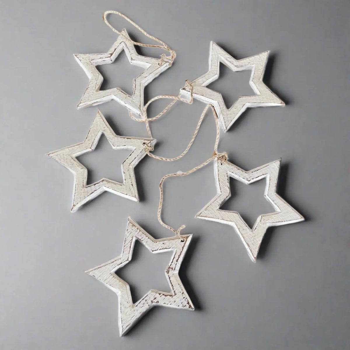 Hanging wooden star decor string by Suzie Blue Canada, open wooden stars for stylish home decoration.