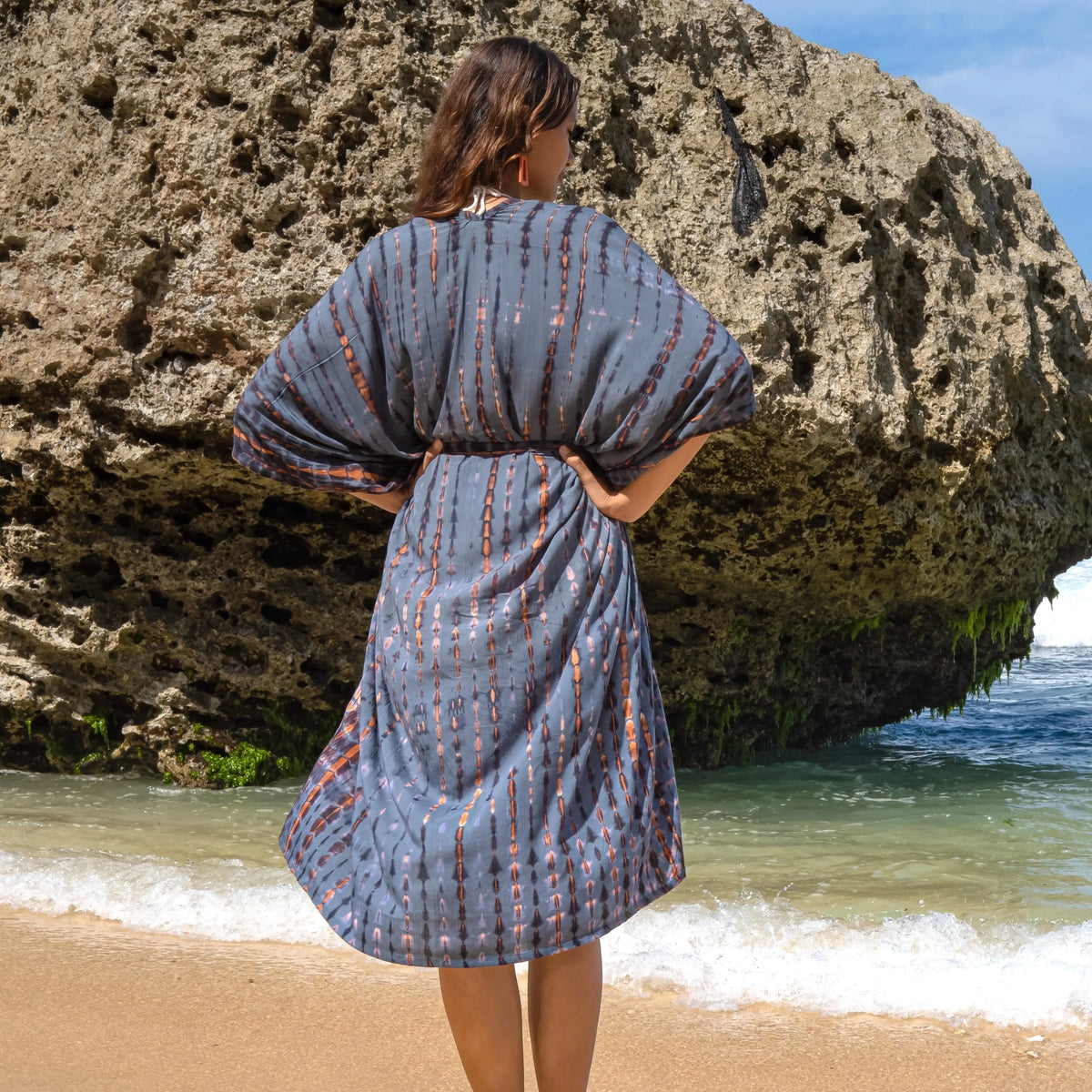 Long denim kimono with gold tie-dye pattern by Suzie Blue Canada, featuring flowing fabric and intricate tie-dye design.