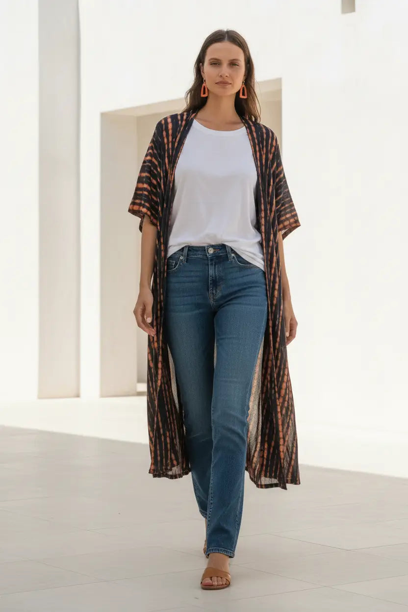 Orange and black tie-dye long kimono by Suzie Blue Canada, featuring a stylish flowy design and waist tie for a fashionable look.