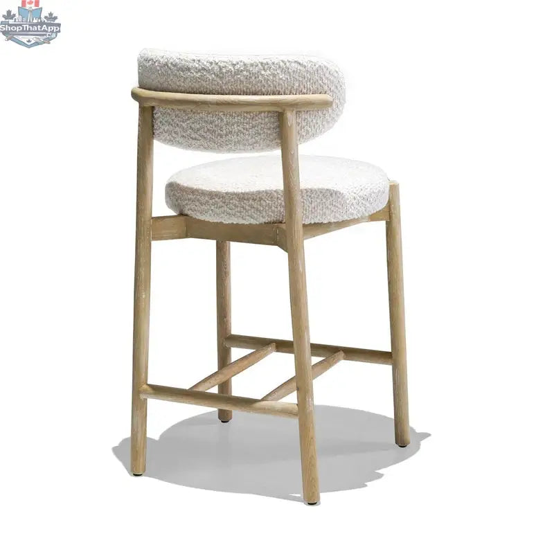Hygge Design House Orazio counter stool with wooden legs and cushioned seat, showcasing modern design and neutral fabric upholstery.