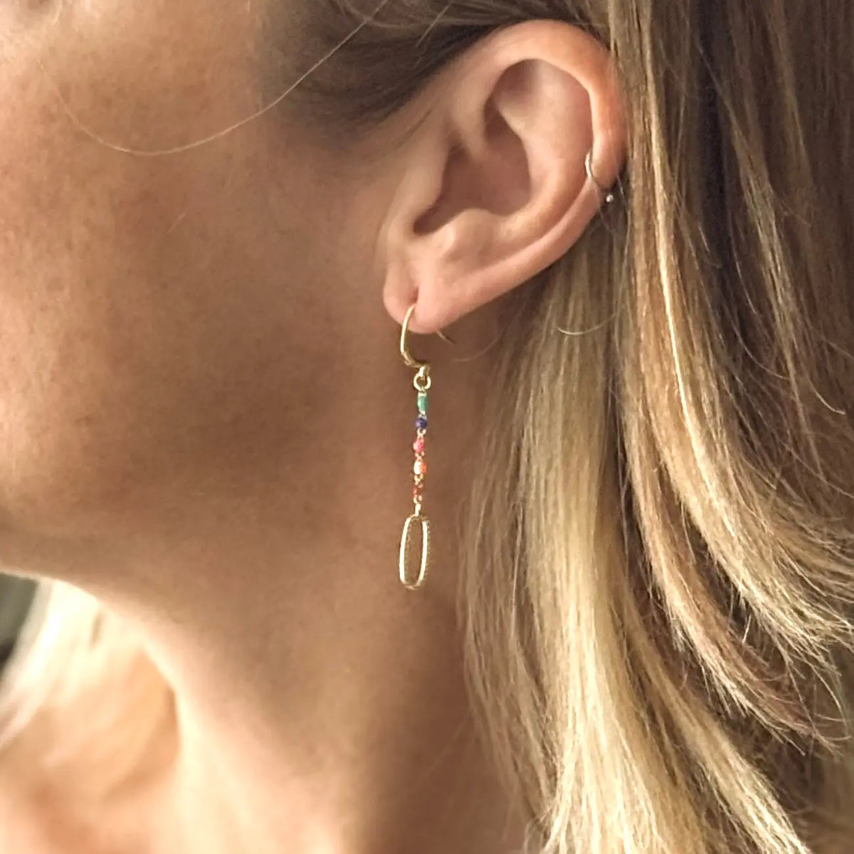 Long chainlink earrings with colorful enamel details by Suzie Blue Canada, featuring intricate metalwork and vibrant accents.