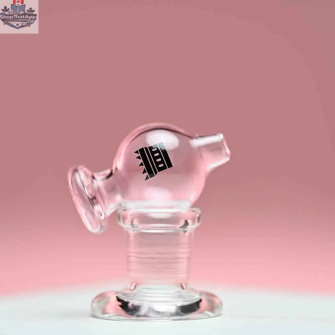 Pink colored bubble carb cap from Castle Glassworks with a matching pink background, designed for concentrate vaporization.
