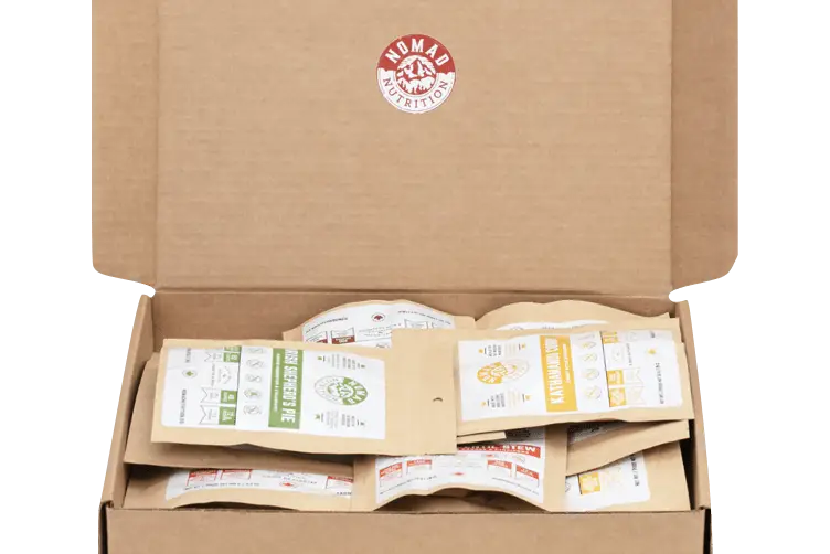 Nomad Nutrition Power Pack with 9 vegan protein single-serving dehydrated food packs in 112g portions, gluten-free and plant-based.
