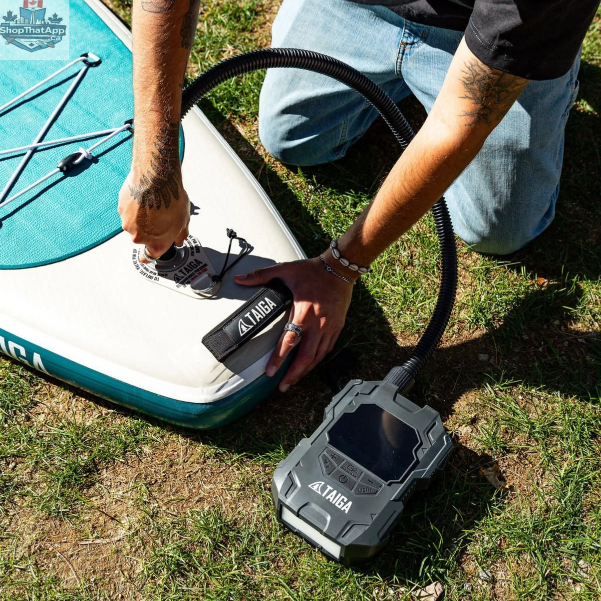 Taiga Board electric pump for paddle boards inflates up to 22 PSI, battery-operated, compact accessory for easy inflating.
