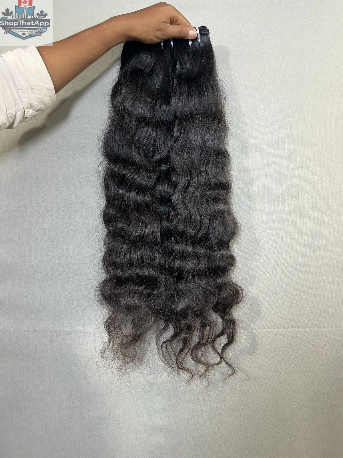 Indian curly human hair extensions from Prithvi Mart, showing three bundles of premium curly hair with natural texture.