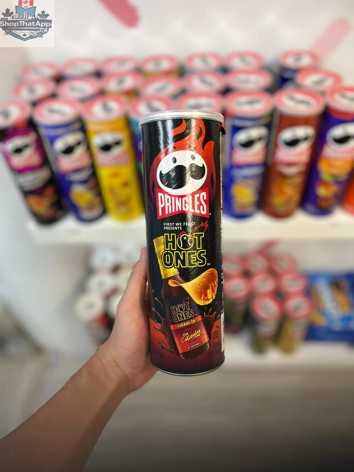 Pringles Hot Ones Barbacoa chips in a red container with spicy flavor, featuring the Snack Bar Co branding and vibrant design.