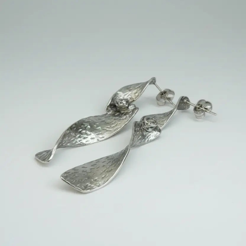 Grey stainless steel twist earring with beaten metal texture by Suzie Blue Canada, showcasing a modern and stylish jewelry design.