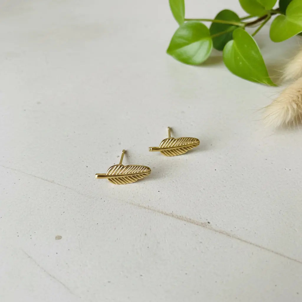Gold-plated leaf stud earrings by Suzie Blue Canada, showcasing elegant, timeless jewelry worn as everyday accessories.