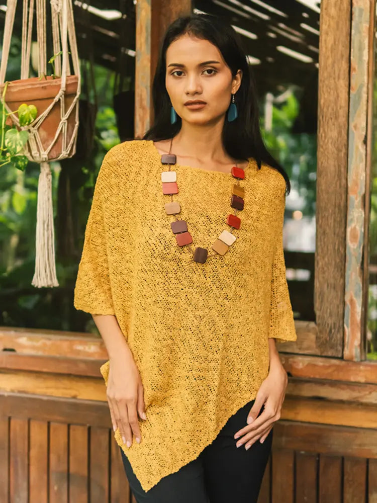 Cozy saffron double knit poncho by Suzie Blue Canada, stylish knitwear with a relaxed fit and textured popcorn pattern.