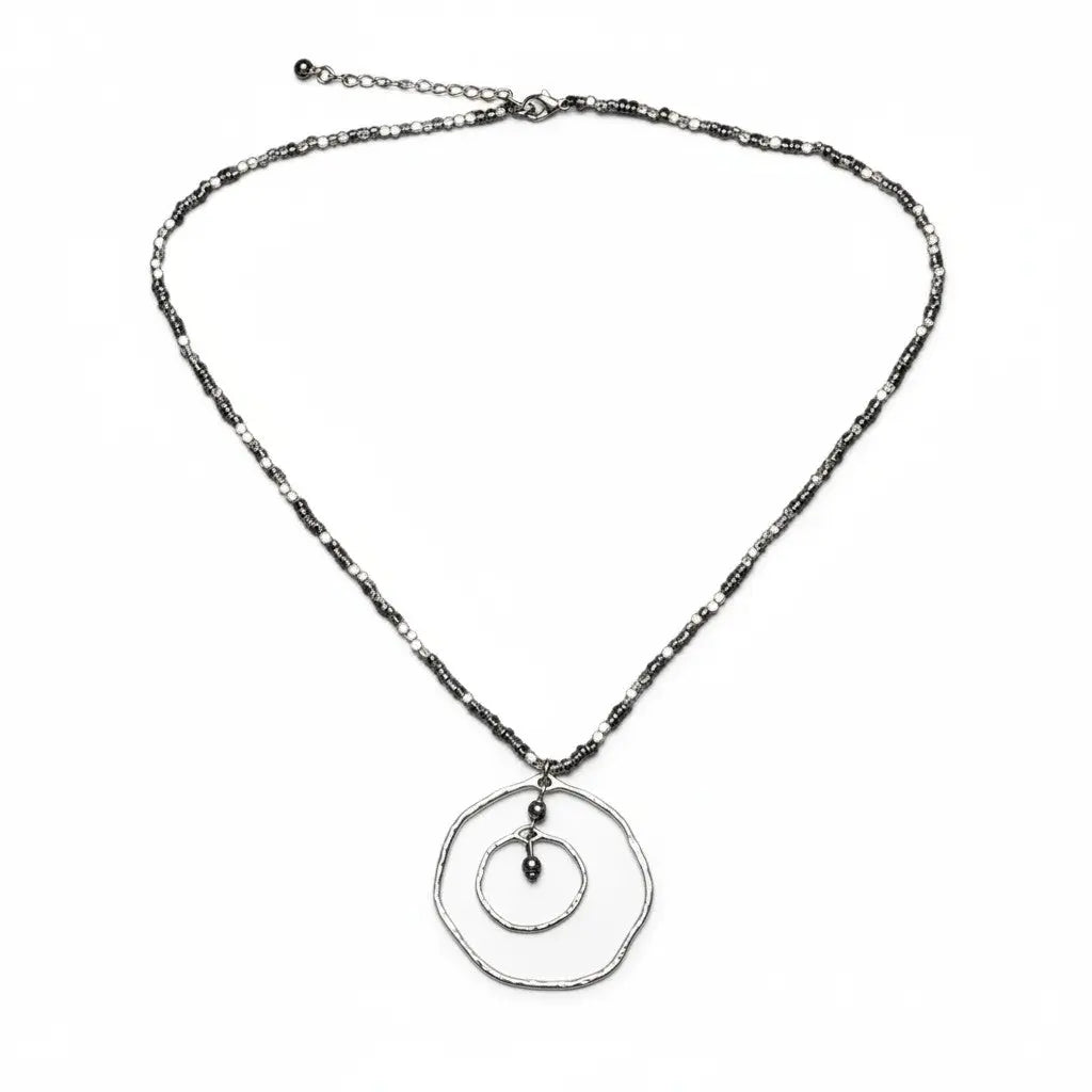 Silver plated Beaten Double Ring Necklace by Suzie Blue Canada featuring an elegant, unique jewelry design with intertwined rings.