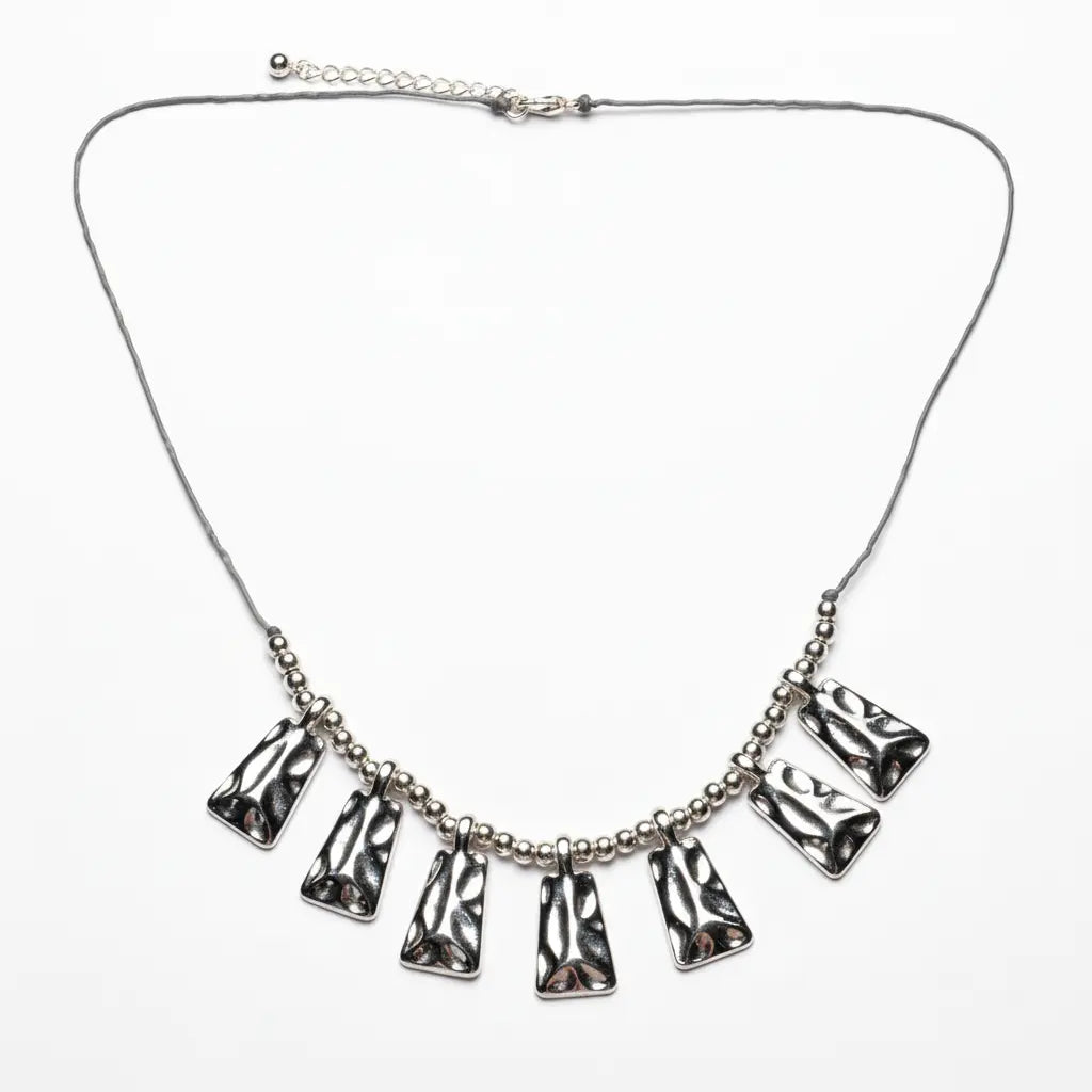 Silver plated Beaten Fan Necklace by Suzie Blue Canada featuring an elegant, textured fan-shaped pendant on a delicate chain.