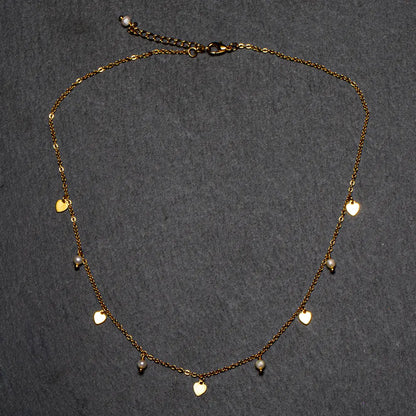 Gold plated pearl heart necklace by Suzie Blue Canada featuring a delicate chain and elegant pearl pendant.