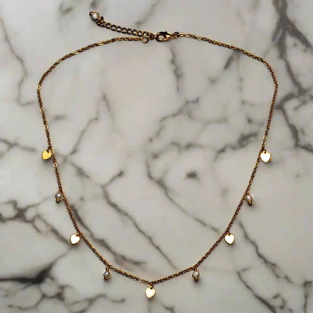 Gold plated pearl heart necklace featuring a delicate chain and a heart-shaped pearl pendant, by Suzie Blue Canada.