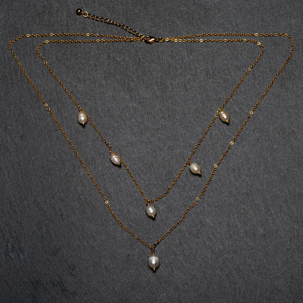 Double strand pearl necklace with gold plated chain by Suzie Blue Canada, featuring lustrous white pearls and elegant design.