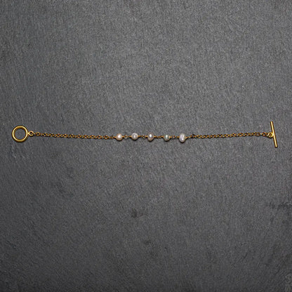 Gold-plated pearl bracelet with chain design, featuring delicate pearls and gold accents, by Suzie Blue Canada.