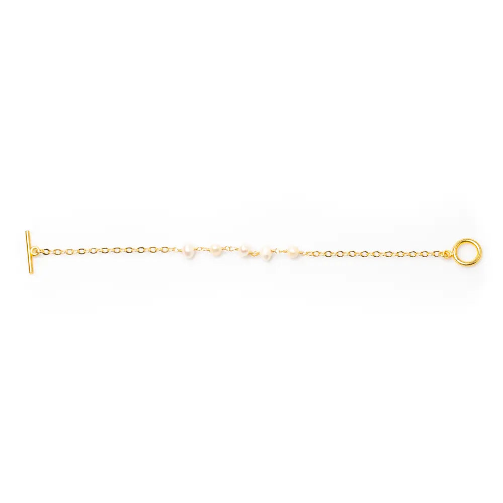 Delicate gold plated pearl bracelet with chain design, showcasing elegant jewelry style and fine craftsmanship.