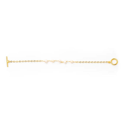 Delicate gold plated pearl bracelet with chain design, showcasing elegant jewelry style and fine craftsmanship.