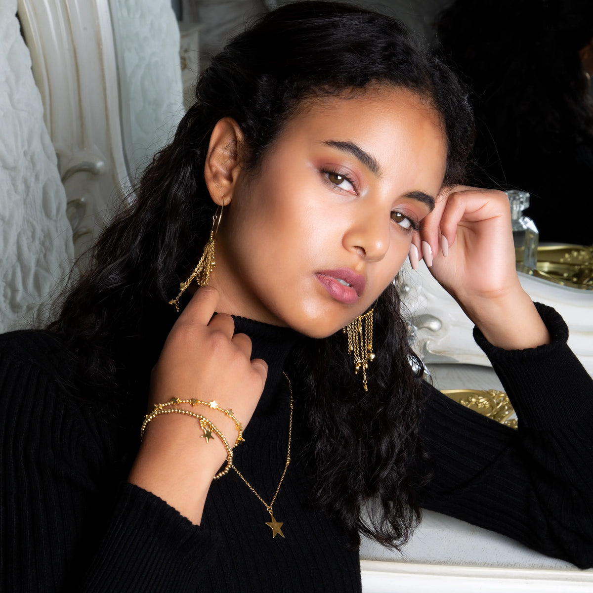 Gold plated star on star chain necklace for women, elegant fashion jewelry by Suzie Blue Canada, featuring layered star pendants.