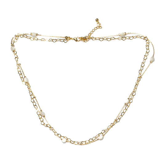 Gold heart chain necklace with white beads, plated in gold, by Suzie Blue Canada, featuring a delicate and stylish design.