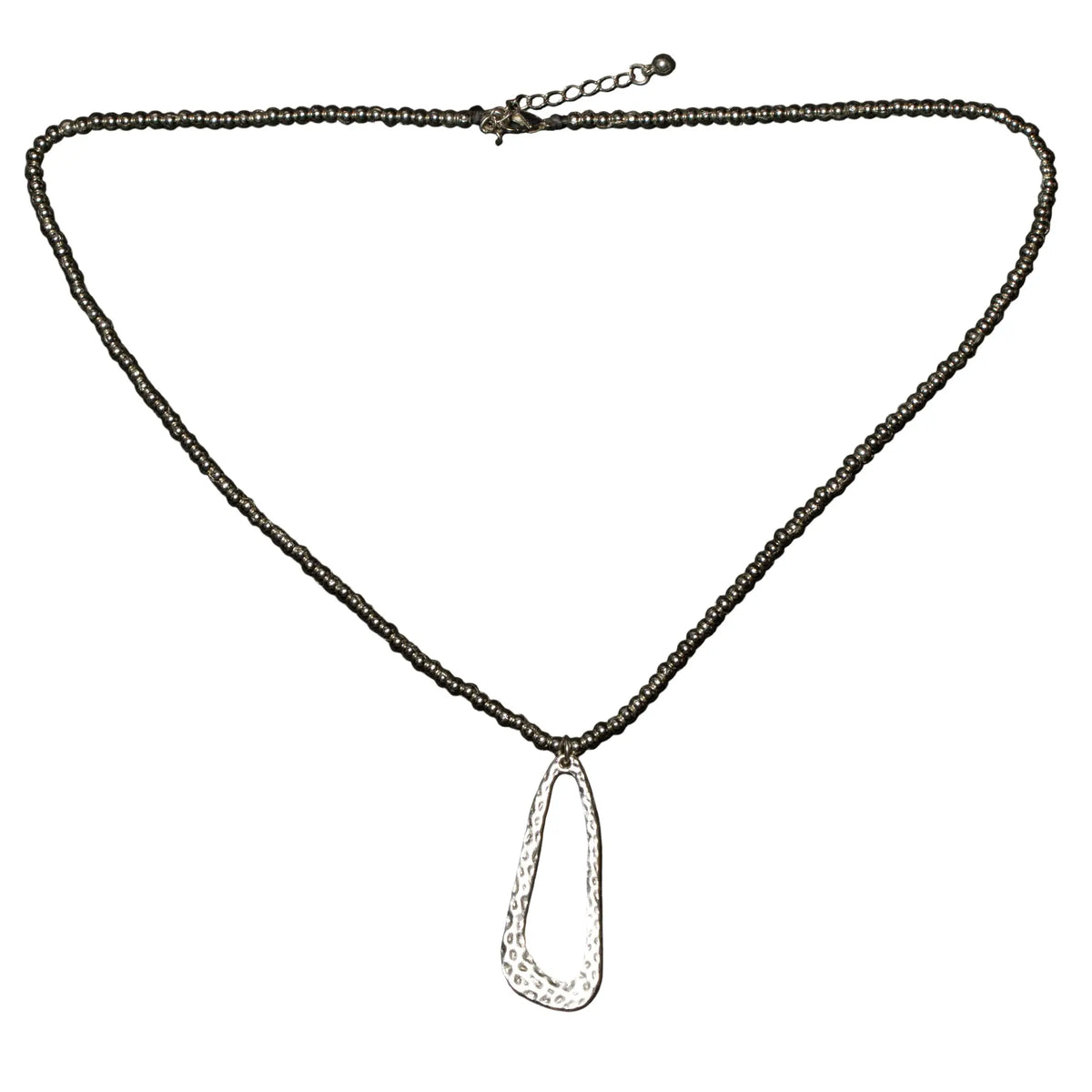 Hammered oval silver plate pendant necklace on ball chain, crafted by Suzie Blue Canada, showcasing a textured, stylish jewelry piece.