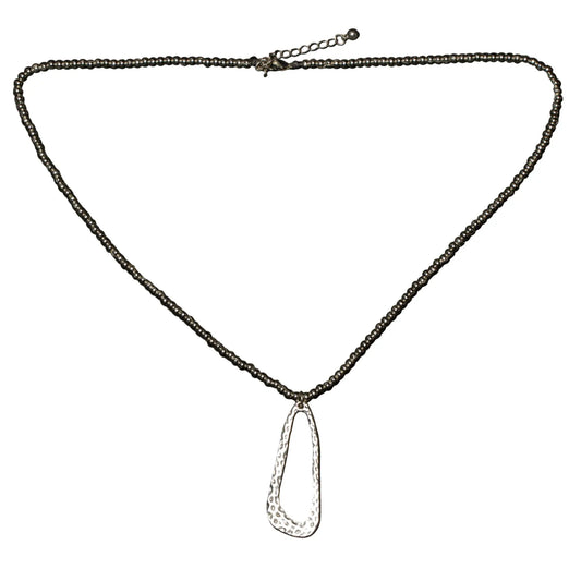 Hammered oval silver plate pendant necklace on ball chain, crafted by Suzie Blue Canada, showcasing a textured, stylish jewelry piece.