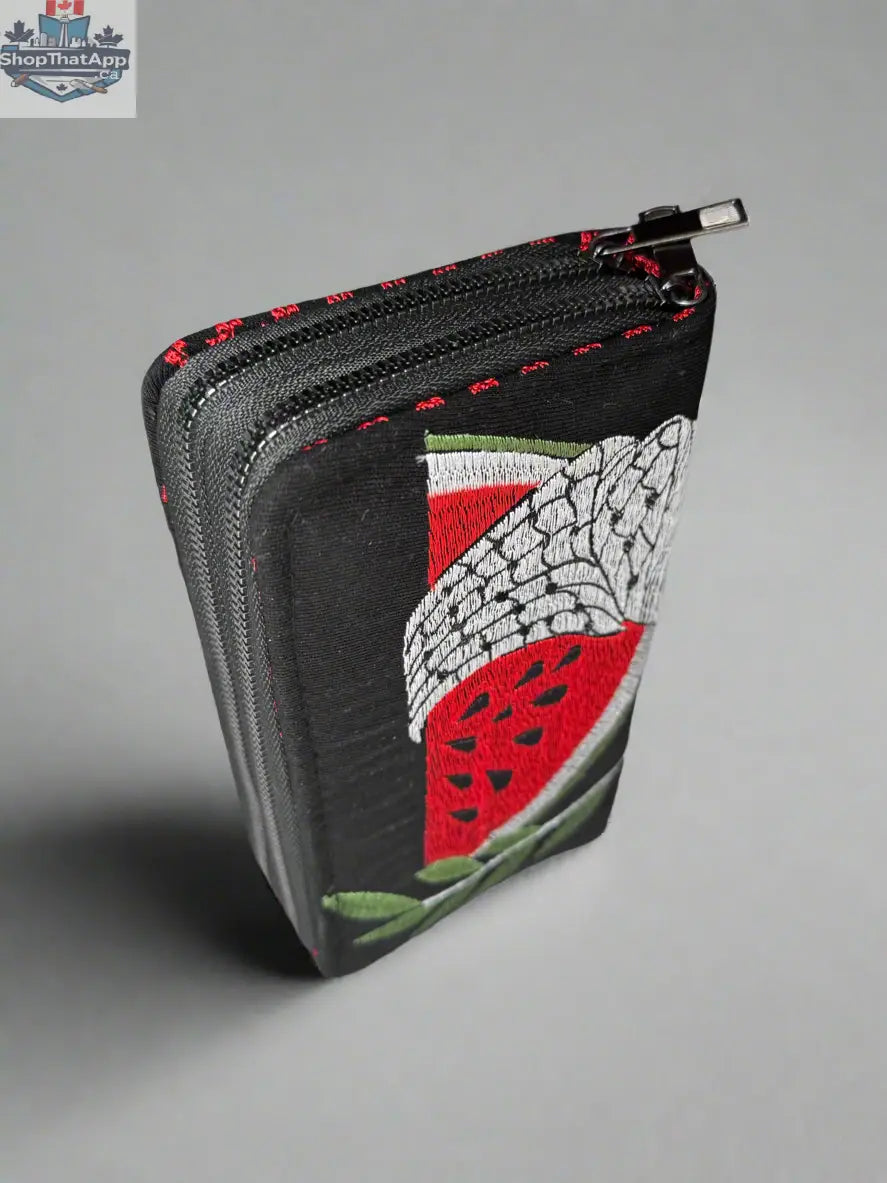 Handheld large Palestinian wallet by The Olive Tree in red, gold, watermelon, or kufiya fabric with traditional patterns.