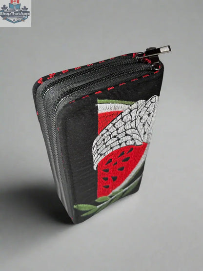 Handheld large Palestinian wallet by The Olive Tree in red, gold, watermelon, or kufiya fabric with traditional patterns.