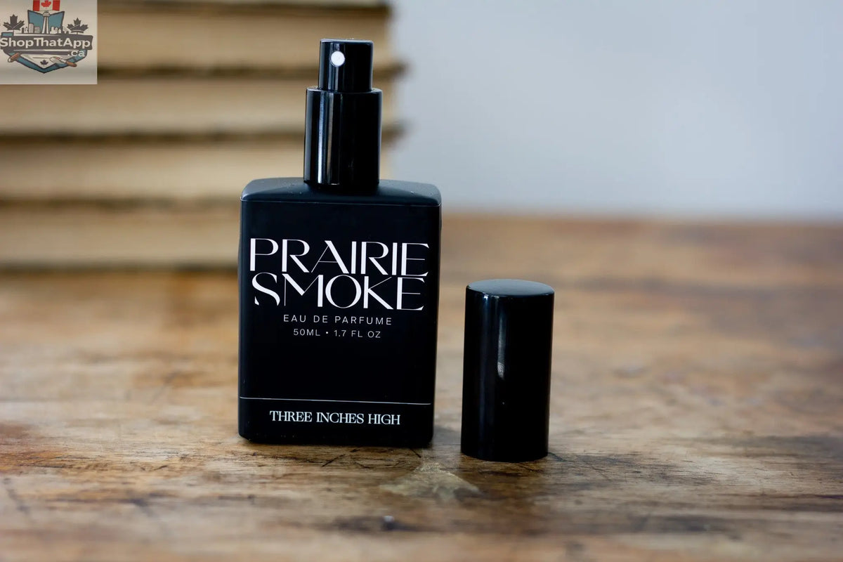Bottle of Three Inches High Prairie Smoke Eau de Parfum with smoky, earthy fragrance in a sleek glass bottle.