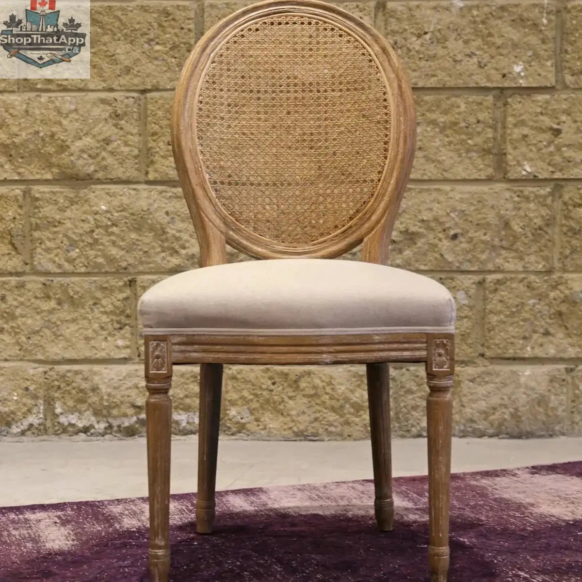 Hygge Design House Napoleon dining chair with antique linen upholstery and cane back, showcasing elegant woodworking and classic design