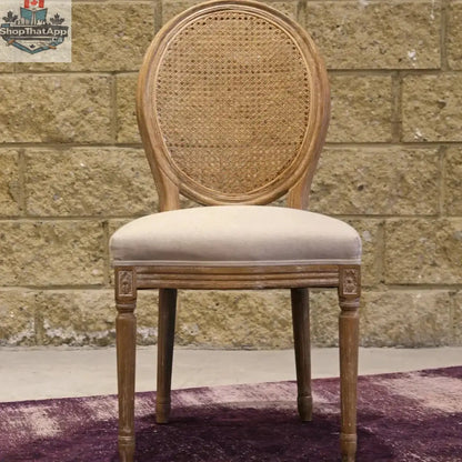 Hygge Design House Napoleon dining chair with antique linen upholstery and cane back, showcasing elegant woodworking and classic design