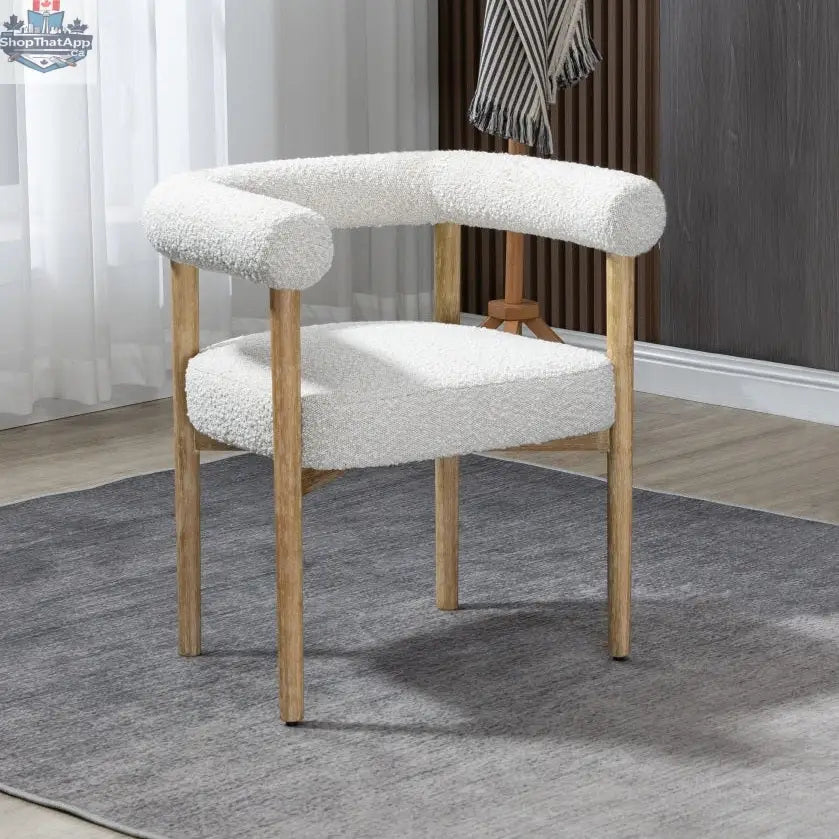 Cream Svea Boucle Dining Chair by Hygge Design House with plush boucle upholstery and modern wooden legs.