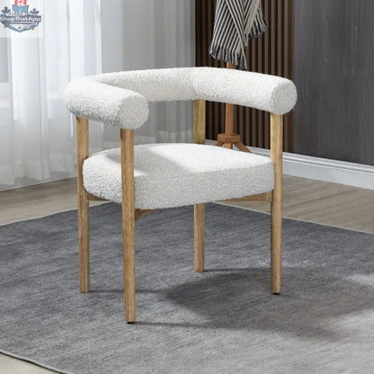 Cream Svea Boucle Dining Chair by Hygge Design House with plush boucle upholstery and modern wooden legs.