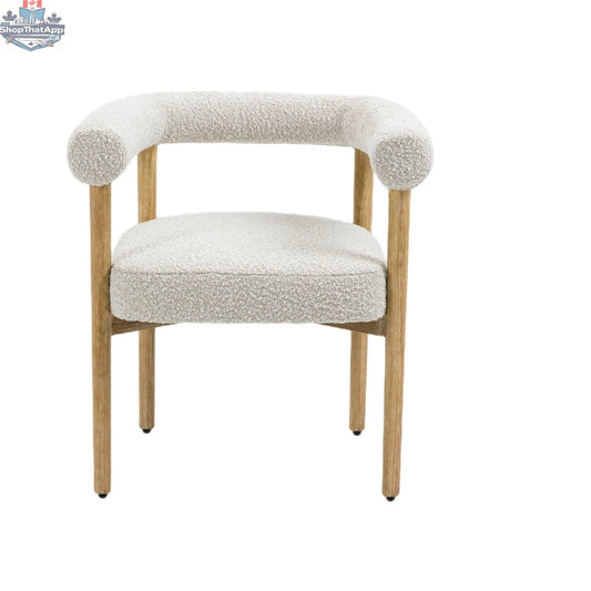 Cream Svea Boucle Dining Chair by Hygge Design House with rounded back and metal legs, showcasing a cozy, modern dining room style.