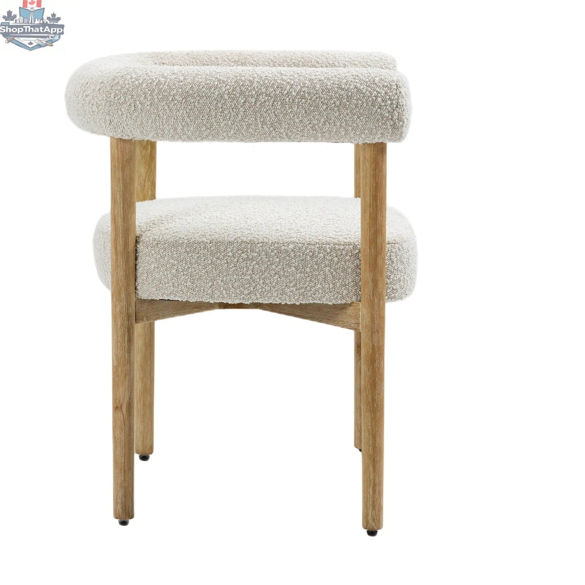 Cream Svea Boucle Dining Chair by Hygge Design House with curved wooden legs and plush boucle fabric upholstery.