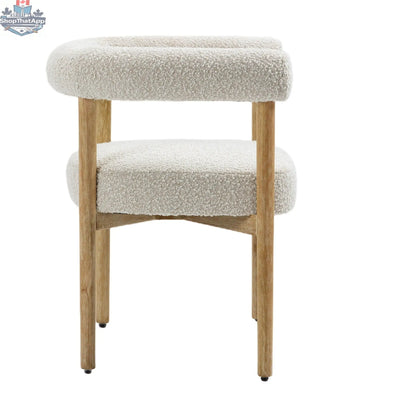 Cream Svea Boucle Dining Chair by Hygge Design House with curved wooden legs and plush boucle fabric upholstery.