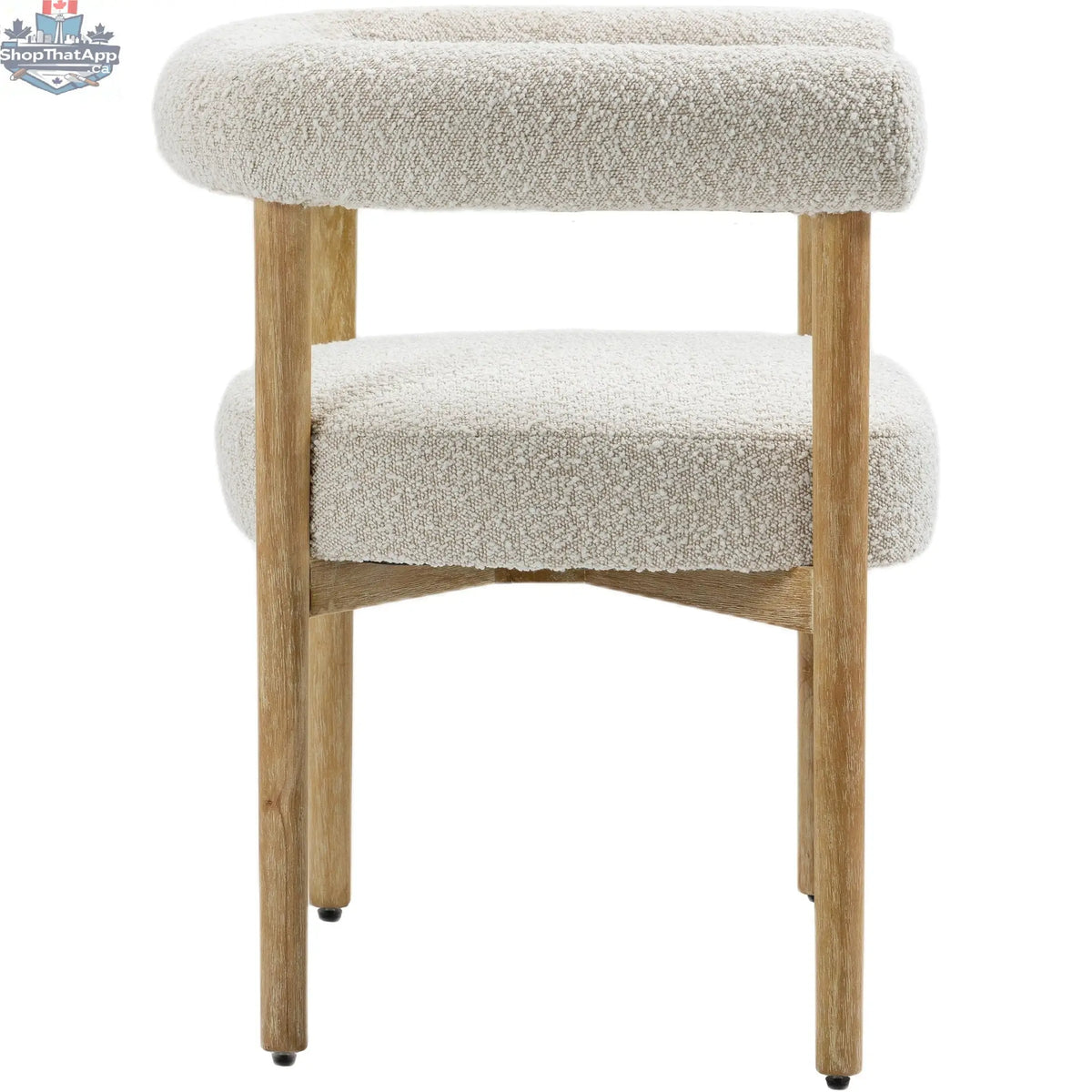 Cream upholstered Oslo dining chair by Hygge Design House with sleek, elegant design and wooden legs.