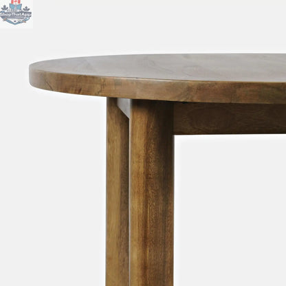 Round dining table by Hygge Design House featuring a smooth wooden surface and modern design for cozy dining spaces.
