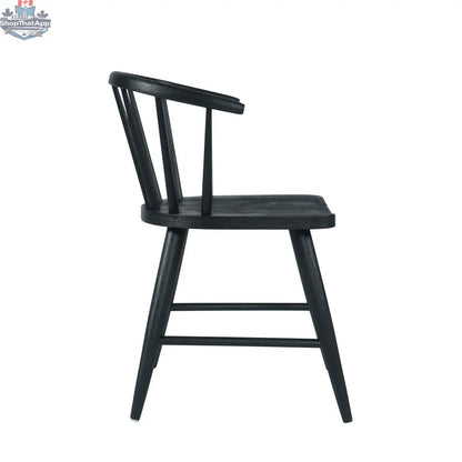Fitz dining chair by Hygge Design House featuring a black upholstered seat and sleek wooden legs.