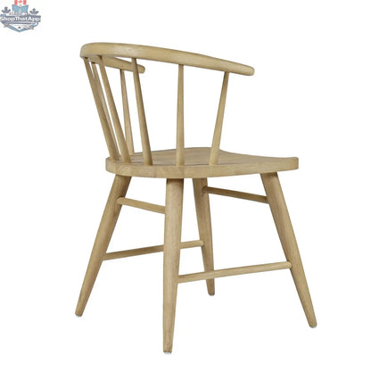Hygge Design House Fitz dining chair shown from side angle with wooden legs and upholstered seat in a modern dining room setting.