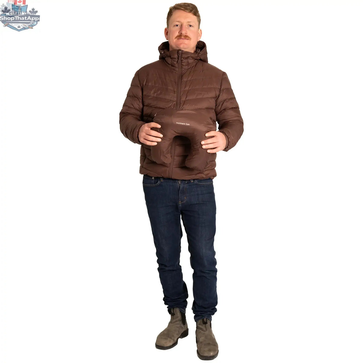Northern Sun packable down jacket shown folded and partially unfolded, lightweight puffer jacket with a hood and zip closure.