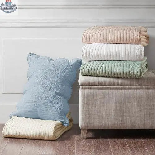 Reversible scalloped edge quilt set comforter by EX-STOCK Canada with three-piece bedding ensemble on a bed.