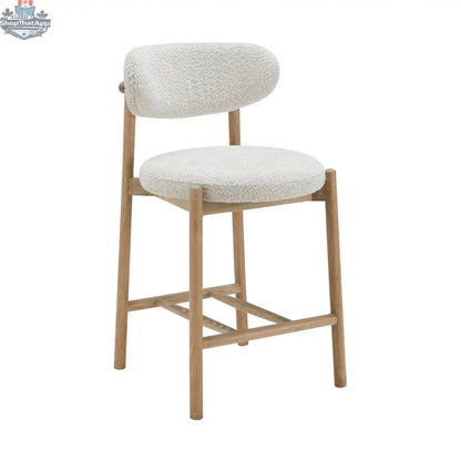 Hygge Design House Orazio counter stool with wooden legs and upholstered seat, shown in a modern interior setting.