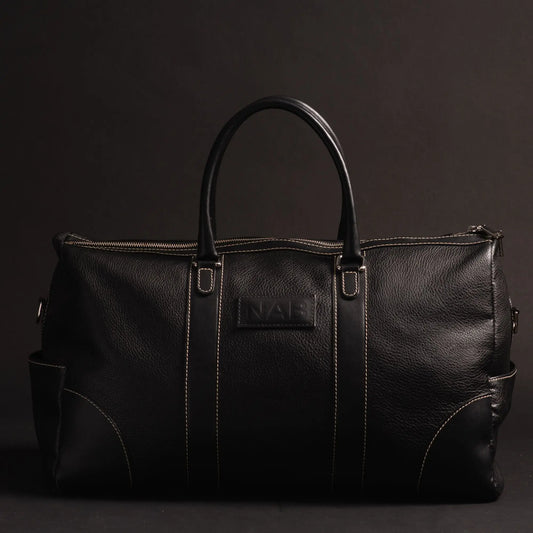 Black full-grain leather duffle bag from NAB Leather, made in Canada, with sturdy handles and spacious interior for travel.
