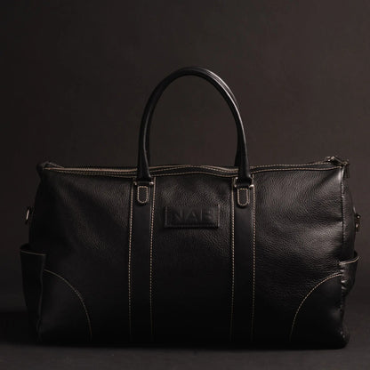 NAB Leather Cognac leather duffle bag, The Shield Duffle, showcasing sturdy handles and spacious interior, crafted in Canada.