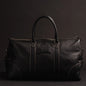 NAB Leather Cognac leather duffle bag, The Shield Duffle, showcasing sturdy handles and spacious interior, crafted in Canada.