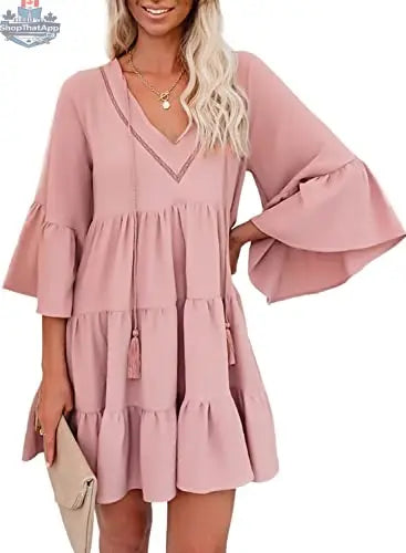 A woman wearing an AILUNSNIKA long sleeve mini dress with a V-neck, solid color, flowy and elegant for stylish comfort.