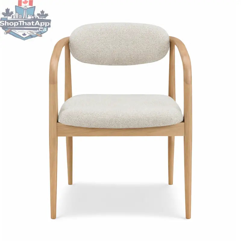 Hedda dining chair by Hygge Design House with wooden legs and upholstered seat in a modern, minimalist style.