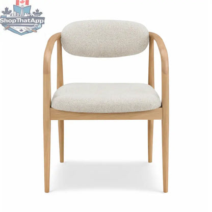 Hedda dining chair by Hygge Design House with wooden legs and upholstered seat in a modern, minimalist style.