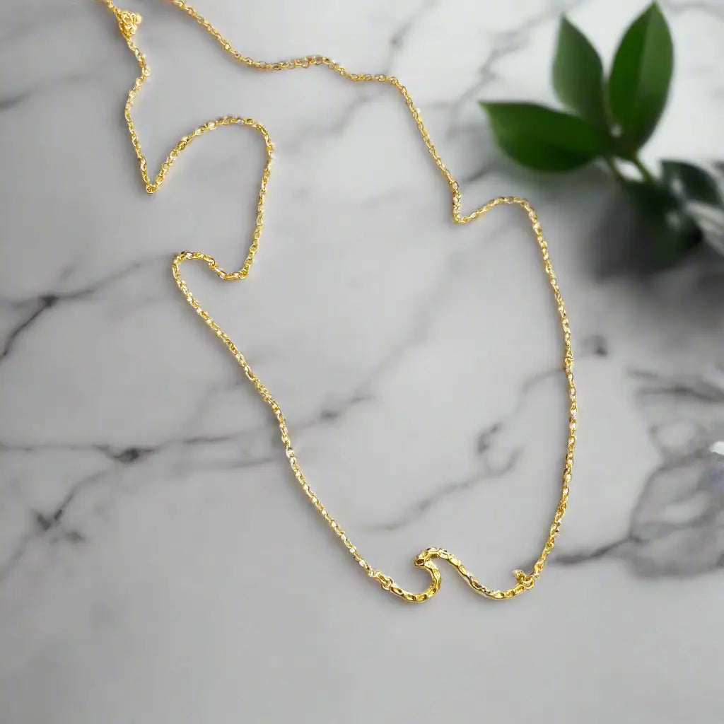 Gold-plated Chainlink Necklace with wave pendant by Suzie Blue Canada, featuring a stylish chain and elegant wave-shaped charm.