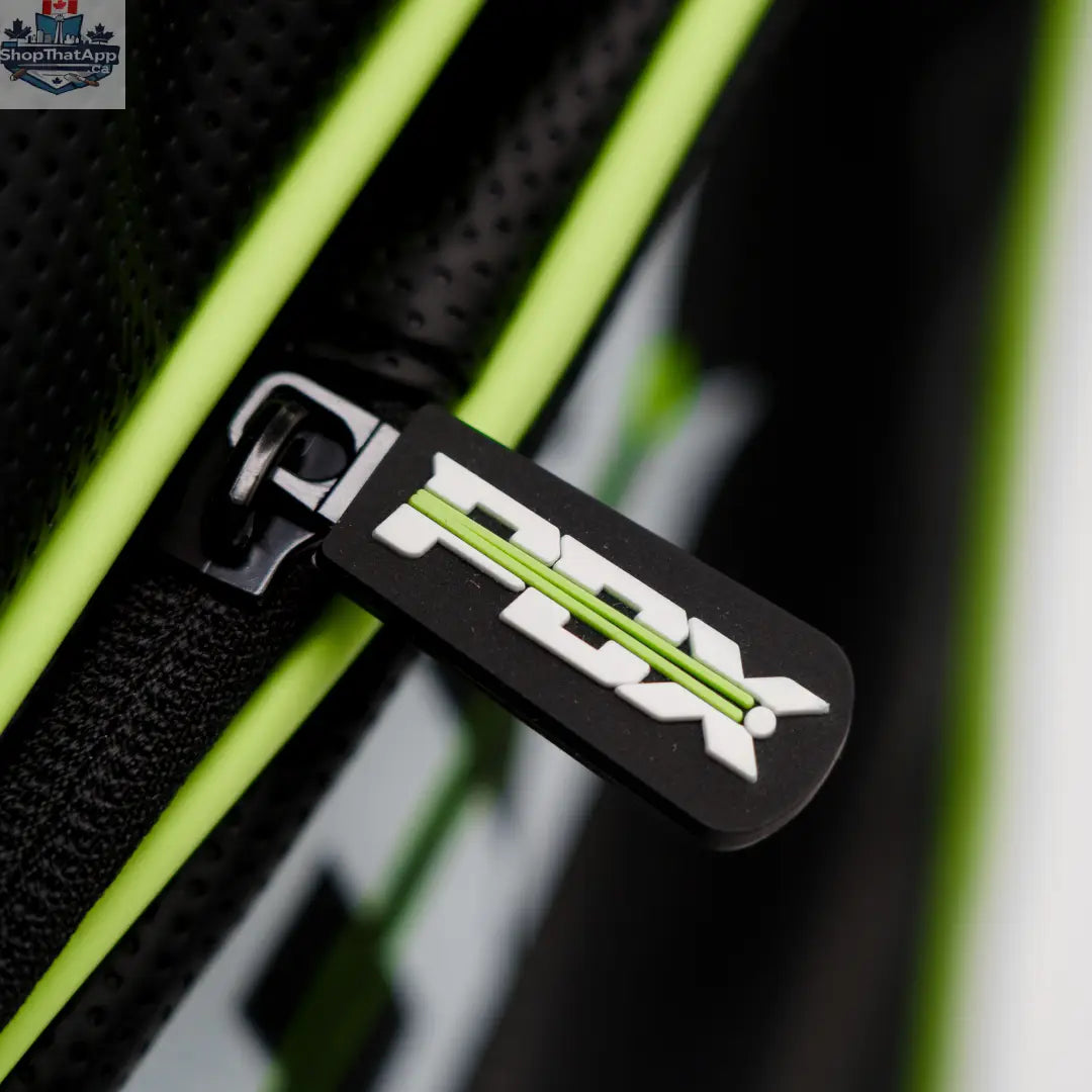 Close-up of a black and neon green fabric bag zipper with a rubber pull tab featuring the PDX logo.